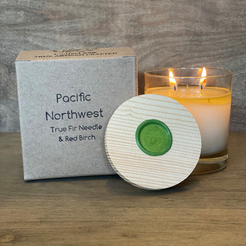 Pacific Northwest 2-wick glass essential oil candle with beeswax and coconut wax blend, featuring Douglas Fir, cypress, lavender, cedarwood, and balsam fir.